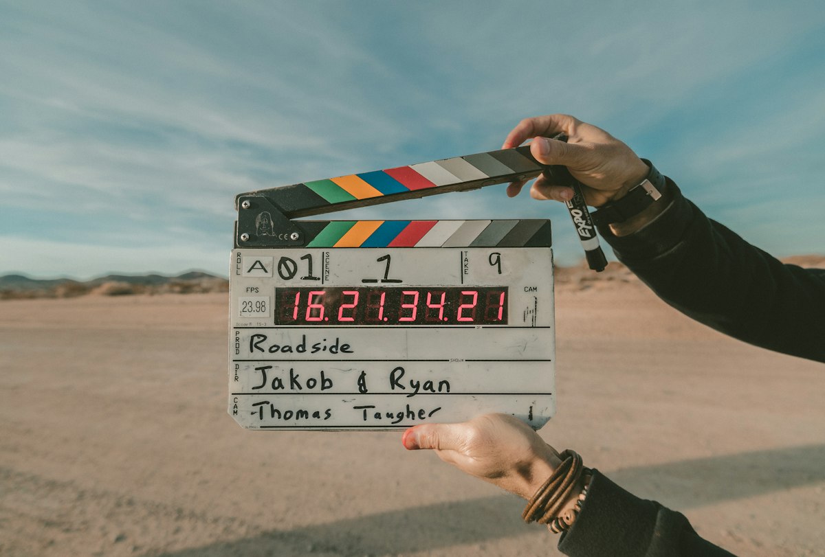 Claqueta de cine sostenida frente a un paisaje